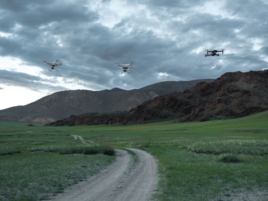 A drone flying over a lush forest, monitoring wildlife and conserving natural habitats.